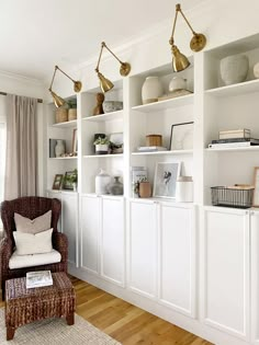 a living room filled with lots of white shelves