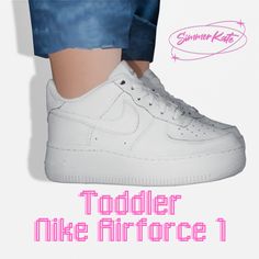 the foot of a person wearing white sneakers with pink lettering on it that reads toddler mike airforce 1