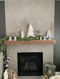 a living room with a fireplace and christmas decorations on top of the mantels