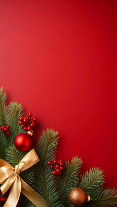 a red christmas background with pine branches and ornaments on it's sides, along with a gold bow