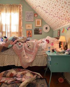 a bed room with a neatly made bed next to a dresser and window covered in pictures