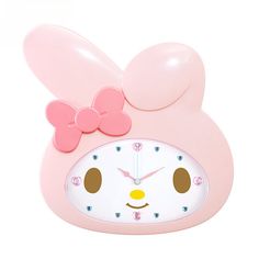 a pink clock with a face and bow on it's head that is shaped like a bunny