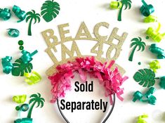 a headband with the words beach m4h sold separately surrounded by palm trees and streamers