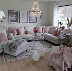 a living room filled with lots of furniture and decor on top of a hard wood floor