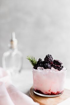 a small glass bowl filled with berries and ice