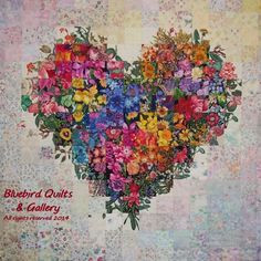 a heart - shaped arrangement of colorful flowers is featured in this quilted photo with the words, bluebird quilts & gallery