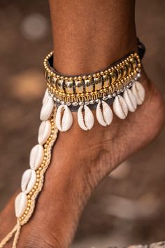 Dhye is a fashionable foot chain that makes a bold statement. With an adjustable string, gold beads and cowrie shells, it is both lightweight and eye-catching. Perfect for a beach vibe or grounding activity, Dhye is your go-to accessory for the goddess in you.  adjustable (fits all sizes)  material: gold beads, faux le Spiritual Anklets For Summer Beach Season, Spiritual Summer Beach Anklets, Adjustable Cowrie Shell Necklace For Beach, Adjustable Beaded Shell Necklace For Vacation, Bohemian Jewelry For Beach Season Parties, Summer Festival Spiritual Jewelry, Spiritual Summer Festival Jewelry, Bohemian Beach Season Party Jewelry, Adjustable Beaded Cowrie Shell Necklace