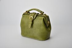 "*DOCTOR BAG'S HANDMADE VIDEO* https://youtu.be/QpdhSCjh2BM Product Description * Material: vegetable tanned leather * Color: Hand-dyeing -olive green * Flap over entry with magnetic buckle closure * 0.75\" wide leather shoulder strap adjust from 36.61\" to 44.88\" * Sewn by hand; * Size: 170mm (H) x 180mm (W) x 110mm (D) / 6.7\" x 7.0\" x 4.3\" The Installation of Doctor Bag Frame #Please see the last picture# Doctor Bag Frame is connected by two pairs of screws. Although we will tighten the sc Grey's Anatomy Derek, Leather Handbags Handmade, Purse Insert, Italian Bags, Bucket Tote, Doctor Bag, Women Leather Backpack, Bag Designs, Bag Green