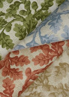 four different colors of fabric with leaves and flowers on them, all in various sizes