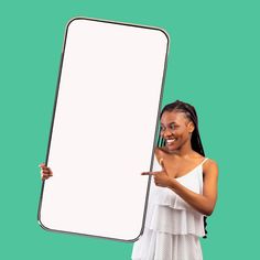 a woman in white dress holding up a blank sign with one hand and pointing at it