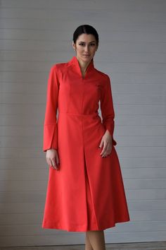 "A structured midi dress featuring high neck collar, long sleeves with cuffs, and a front pleated skirt. - high neck collar - fit and flare silhouette - midi length (belove the knee) - long sleeves with cuffs - front pleated skirt - structured silhouette - 1950s style - concealed back zipper closure Color: coral red Fiber: viscose - 40%, elastane - 5%, polyester - 55% For Size S (8 US): dress length - 45,5\" (116 cm), sleeve length - 24'' (61 cm) Our model wears size S and is 171cm/5'6\" tall MO Long Sleeve Dress Elegant, Midi Wedding Guest Dress, Elegant Cocktail Dress, Dress High Neck, Flare Long Sleeve, 1950s Style, Red Fits, Maxi Dress Cocktail, Coral Red