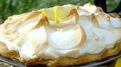 a lemon meringue pie sitting on top of a table