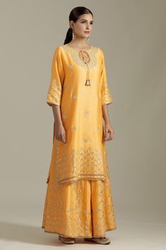 Mango chanderi silk kurta with gotapatti embroidered floral motifs and dori embroidery. Comes with sharara and dupatta.
Components: 3
Pattern: Embroidered
Type Of Work: Gota patti
Neckline: Keyhole
Sleeve Type: Three quarter
Fabric: Chanderi Silk,Net
Color: Yellow
Other Details: 
Tasselled tie detail
Attached lining
Closure: Sharara: Elasticated waistband
Occasion: Mehendi and Haldi,Sangeet - Aza Fashions Navratri Raw Silk Sets With Cutdana, Traditional Dola Silk Sharara For Transitional Season, Traditional Slub Silk Sharara With Dori Work, Navratri Slub Silk Sets With Dori Work, Raw Silk Sets With Cutdana For Eid, Traditional Raw Silk Sharara With Dori Work, Slub Silk Palazzo Set With Dori Work For Diwali, Traditional Silk Sharara With Dori Work, Slub Silk Sharara With Straight Kurta For Eid