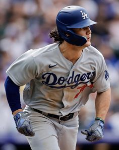 a dodgers baseball player running on the field