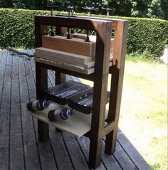 an outdoor bbq grill on a wooden deck