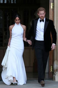 prince harry and his bride are walking out of the royal palace after their wedding ceremony