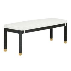 a black and white bench with gold legs