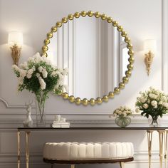 there is a table with flowers and a mirror on the wall