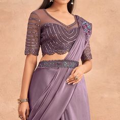 Mauve colored stitched saree is made from art silk fabric which is highlighted with sequins embroidered work as shown. comes along with sequins embroidered soft net blouse piece which you can customise as per your design/style. Occasion - You can wear this saree for parties, functions and events. Note:- the actual product may differ slightly in color and design from the one illustrated in the images when compared with computer or mobile screen. Unstitched Organza Blouse Embroidered Fabric For Designer Wear, Designer Wear Unstitched Organza Blouse Fabric, Designer Embroidered Unstitched Organza Blouse, Designer Wear Unstitched Organza Blouse, Sequin Chanderi Pre-draped Saree For Reception, Purple Embellished Pre-draped Saree, Embellished Purple Pre-draped Saree, Traditional Drape Sequined Blouse For Diwali, Diwali Sequined Traditional Drape Blouse Piece