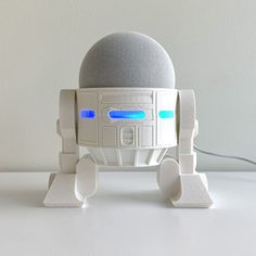 a white robot toy sitting on top of a table