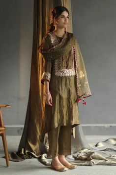 Olive green chanderi kurta with hand embroidered buttis and detailed mirror work across the yoke. Paired with pants and a checkered organza dupatta with sheesha buttis and rose tassels with gota detailing. Comes with an inner.
Component: 4
Embroidered
Neckline: Notched
Sleeve Length: Three Quarter
Fabric: Kurta and Pant: Chanderi; Dupatta: Organza; Inner: Mulmul
Color: Green
Mirror work, hand embroidered floral buttis, and hand sequins embroidery
Contrast lace on dupatta - Aza Fashions Luxury Banarasi Silk Kurta With Zari Work, Luxury Handwork Straight Kurta Set, Luxury Kurta With Mirror Work For Traditional Ceremonies, Luxury Traditional Straight Kurta Embroidered Fabric, Luxury Designer Kurta With Traditional Fit, Luxury Kurta With Dabka Work For Traditional Ceremonies, Luxury Handwork Kurta With Traditional Drape, Luxury Embroidered Kurta With Traditional Drape, Luxury Embroidered Choli Straight Kurta