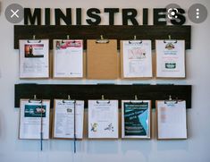 a bulletin board with clipboards attached to it