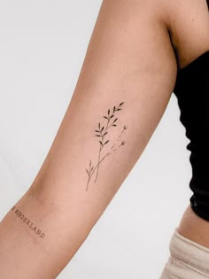 a woman's arm with a small tattoo on the left side of her arm