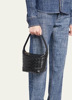 "Find BOTTEGA VENETA Candy Wallace Top Handle Bag on Editorialist. The Bottega Veneta Candy Wallace bag is crafted from intrecciato leather. It features an adjustable top handle that can be worn as a top handle or a shoulder strap. The bag has a zip top closure and measures approximately 6.7\"H x 5.3\"W x 4.5\"D. It is made in Italy." Designer Woven Leather Shoulder Bag For Evening, Luxury Woven Leather Bag For Evening, Evening Leather Bag With Intrecciato Weave, Leather Evening Bag With Intrecciato Weave, Evening Pouch Shoulder Bag With Intrecciato Weave, Evening Shoulder Bag With Double Handle In Woven Leather, Leather Bags With Intrecciato Weave For Evening, Elegant Woven Leather Evening Bucket Bag, Evening Shoulder Bag With Double Handle And Woven Leather