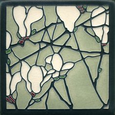 a stained glass window with green and white designs on it's sides, in the shape of a map