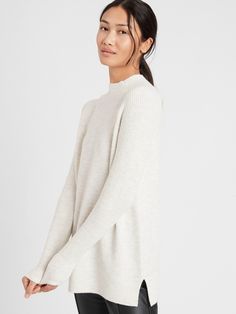 SOFT & WARM: Made with a blended yarn with rayon for softness and Merino wool for extra warmth.  SEMI-FITTED: Cut for a not-too-tight, not-too-loose fit.  Mock neck.  Ribbed-knit sleeves.  Straight hem.  Semi-fitted.  Long sleeves.  Tunic length.  Body length (size S): Petite 25", Regular 27" Sleeve length: Petite 29", Regular 30" Model: Size XS, 5'10" (178cm) Soft Knit Relaxed Fit Funnel Neck Sweater, Cozy Relaxed Fit Knit Top For Layering, Stretch Merino Wool Sweater For Layering, Daywear Sweater In Soft Knit With Relaxed Fit, Daywear Soft Knit Relaxed Fit Sweater, Stretch Soft Knit Funnel Neck Sweater, Soft Knit Sweater For Daywear, Relaxed Fit, Soft Knit Stretch Sweater With Funnel Neck, Cozy Soft Knit Daywear Sweater