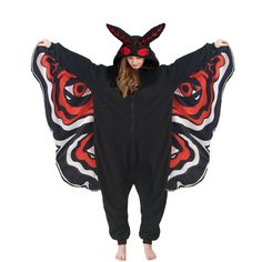 a woman wearing a black and red butterfly onesuit with ears on her head, standing in front of a white background