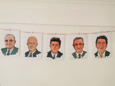 five portraits of men hanging on a line in front of a white wall with red string