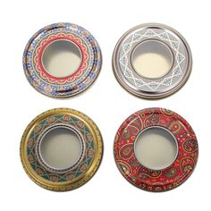 four different colored plates with designs on them