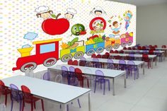 there are many tables and chairs in this classroom with a mural on the wall behind them