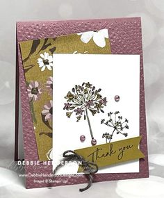 a card with a dandelion on it and a thank you tag hanging from the front