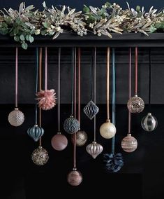 an assortment of ornaments hanging from a mantle