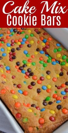 a cake mix cookie bar with lots of candy and m & m on top in a pan