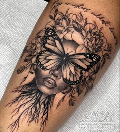 a woman's face with a butterfly on her head, surrounded by branches and flowers