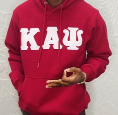 Exclusive Kappa Alpha Psi Double Stitched Appliqué Embroidery Lettered Hoodie. This is the perfect long-sleeved hoodie to wear while showing off your Kappa Alpha Psi fraternity lettering. A comfortable 100% cotton tee with a twill Greek letters embroidery across the chest give you the perfect fit. This hoodie is also a perfect gift for your favorite Kappa Man. Fast Shipping & Processing: 1-2 days to process US Domestic Shipping: 3-5 business days International Shipping: 7-14 business Cotton Varsity Hoodie With Long Sleeves, Varsity Hoodie With Letter Embroidery For Winter, Collegiate Long Sleeve Fleece Hoodie, Spring College Hoodie In Fleece, Spring College Fleece Hoodie, Red Letter Embroidery Sweatshirt For Fall, Long Sleeve Hoodie For College In Fall, Spring Fleece Hoodie For College, Double-lined Hooded Long Sleeve Top