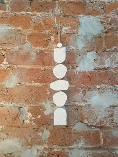 three white circles hanging on a brick wall