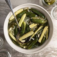 a white bowl filled with pickles and onions