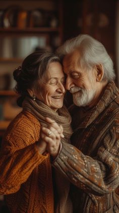 an older man and woman hugging each other