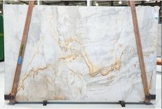 a large marble slab is on display in a store with two wooden poles sticking out of it