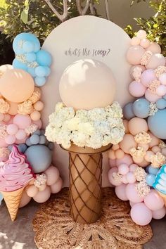 an ice cream cone surrounded by balloons and flowers