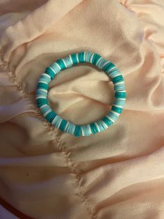 This bracelets primary colors are white teal and baby blue. Trendy Turquoise Bracelets, Trendy Light Blue Friendship Bracelets, Casual Turquoise Beaded Bangle Bracelets, Trendy Light Blue Friendship Bracelet, Trendy Blue Friendship Bracelets, Trendy Blue Stretch Bracelet With Round Beads, Trendy Blue Beaded Bracelets For Friendship, Trendy Blue Beaded Bangle Bracelet, Blue Beaded Wristband As Gift