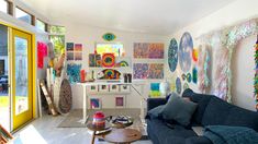 a living room filled with furniture and lots of art