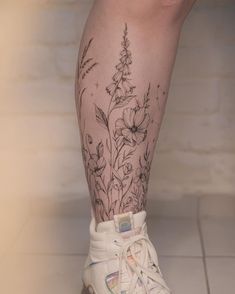 a close up of a person's legs with flowers on them