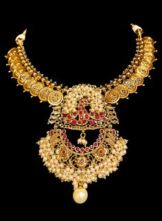 Kedar - Traditional Coin Temple Jewelry w/ Cluster Pearls & Ruby Peacock work Luxury Temple Jewelry Bridal Necklace With Stones, Luxury Gold Temple Necklace With Stone Work, Luxury Ceremonial Temple Necklace With Tilla Detail, Luxury Ceremonial Pendant Temple Necklace, Luxury Temple Jewelry For Wedding And Ceremonial Occasions, Luxury Temple Jewelry For Diwali, Luxury Black Temple Jewelry, Luxury Fusion Style Temple Necklace With Intricate Design, Luxury Festive Temple Jewelry Earrings