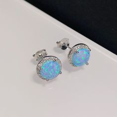 "'Blue Opal Large Stud Earrings, Opal Earrings with diamond simulants, Opal Disc Earrings, October Birthstone jewelry, Sterling Silver Studs' Sterling Silver Blue Opal Earrings. It is made of solid British Sterling Silver and rhodium plating.  Rhodium-plated silver is fine sterling silver that is polished and dipped in rhodium. It has a bright finish, similar to white gold items, and it doesn't tarnish.  ✨ For free giveaways, special offers and latest design updates, simply follow us on Facebook Diamond White Crystal Earrings Fine Jewelry, Round Halo Earrings As A Gift, Round Halo Earrings For Gift, Round Halo Earrings Perfect For Gifts, Dazzling Round Earrings With Sparkling Stones, Sterling Silver Earrings With Sparkling Stones, Sparkling Stone Round Earrings For Anniversary, Round Earrings With Sparkling Stones For Anniversary, Round Cluster Earrings With Sparkling Stones For Gift