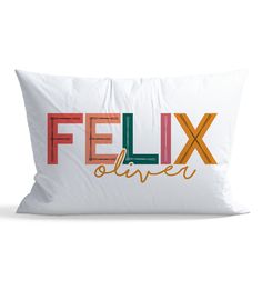 a white pillow with the word'flix'in multicolored letters on it